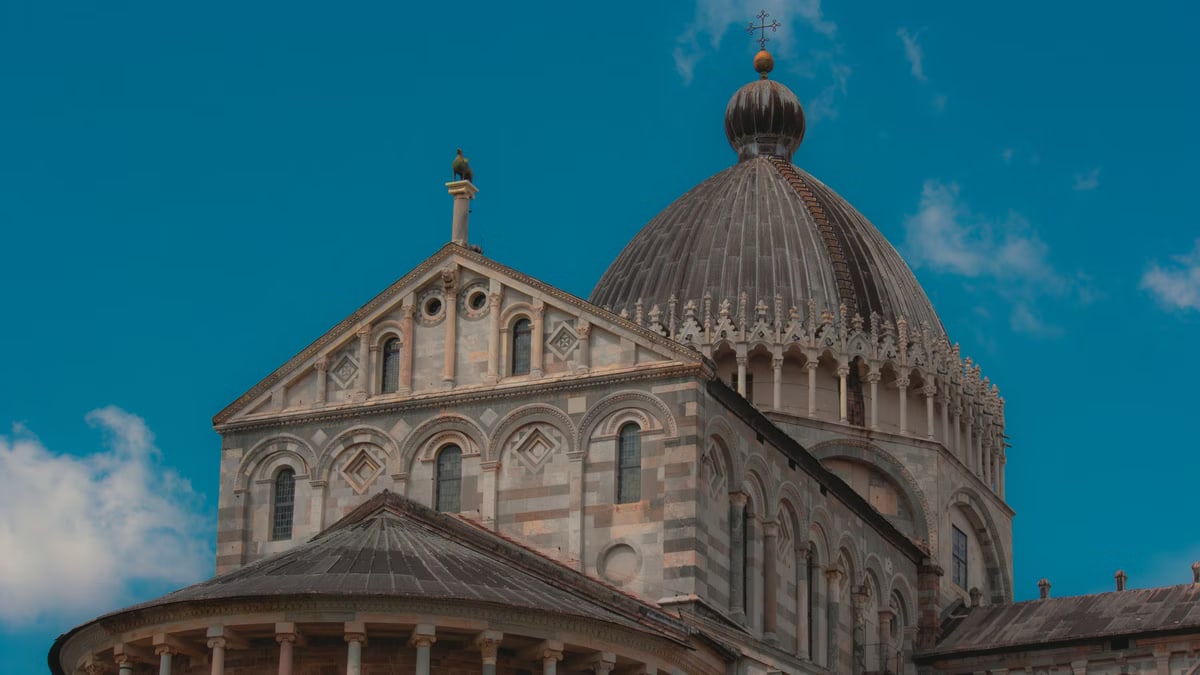 Stunning view of the Pisa Cathedral under a clear blue sky, showcasing its architectural beauty.